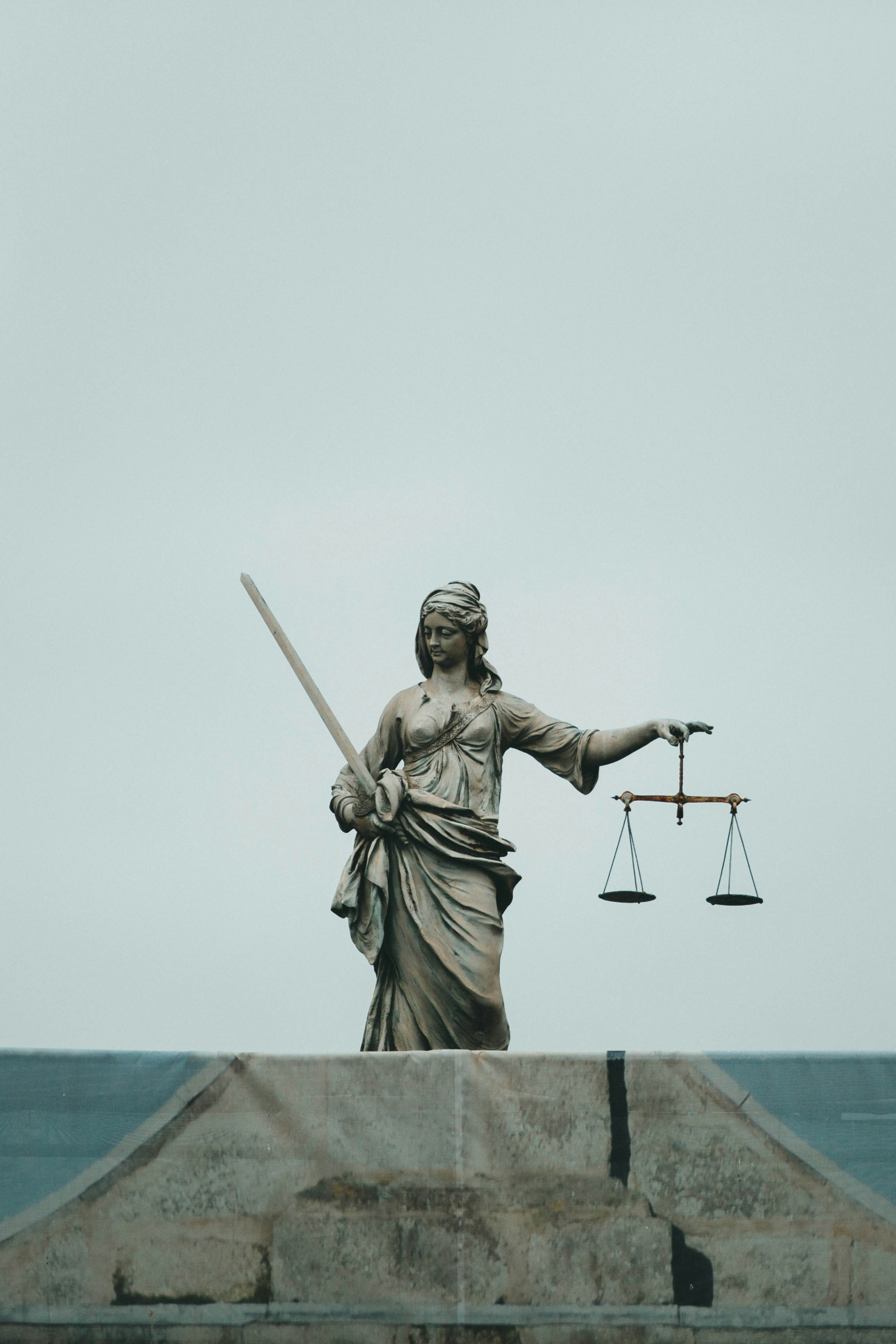 Neutral legal image - lady justice on top of a building.